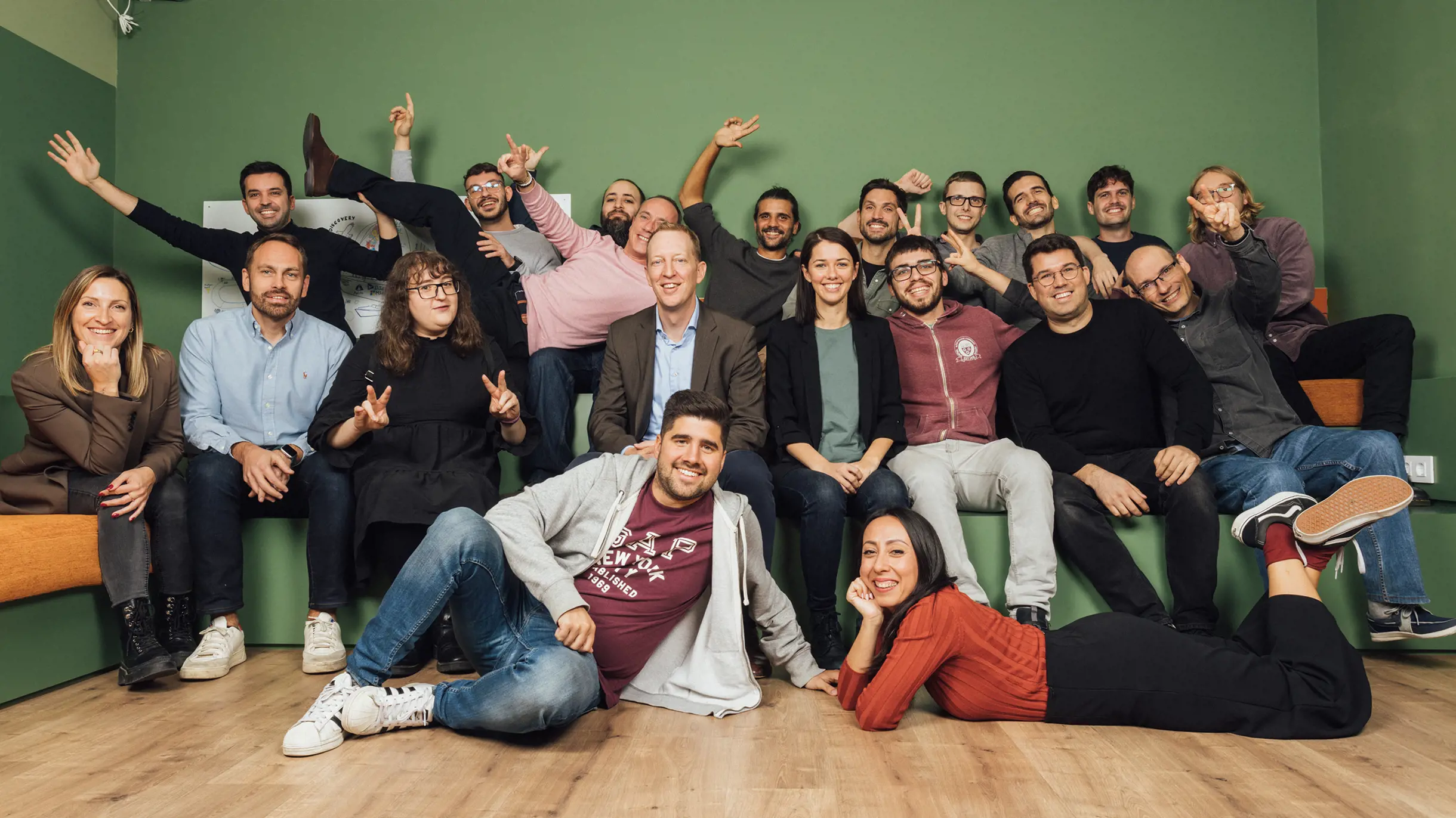 Team picture in front of a green background